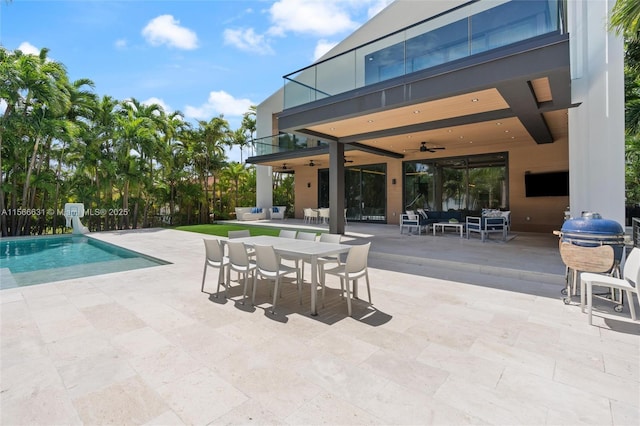 view of swimming pool featuring outdoor lounge area, a patio, and ceiling fan