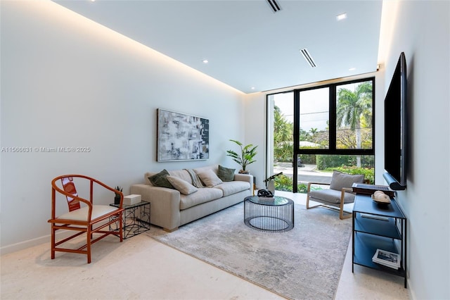 living room with expansive windows and a towering ceiling