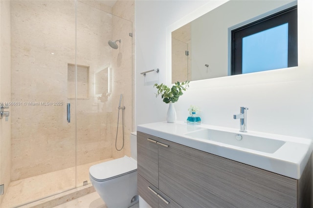 bathroom featuring vanity, toilet, and a shower with door