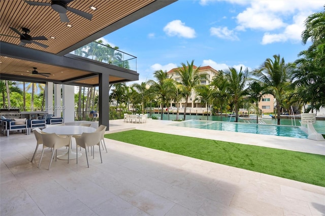 view of pool with a patio, pool water feature, area for grilling, and ceiling fan