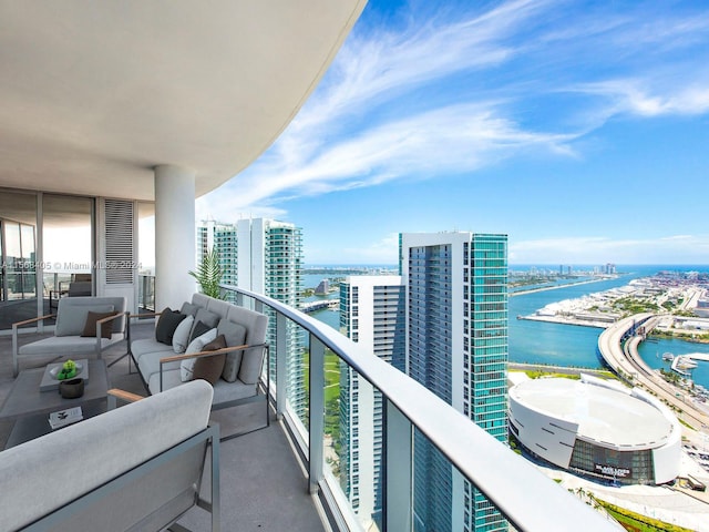 balcony featuring a water view and an outdoor hangout area