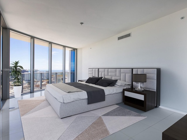 tiled bedroom with floor to ceiling windows and access to exterior