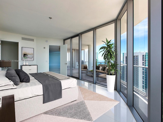 bedroom featuring tile flooring, access to outside, and a wall of windows