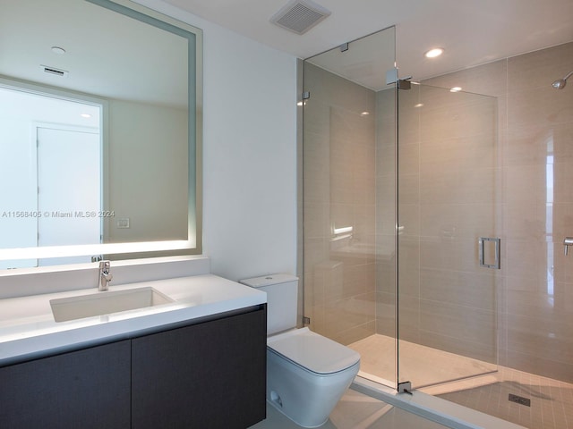 bathroom featuring an enclosed shower, toilet, and large vanity