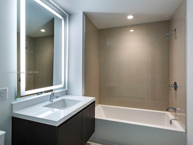 bathroom with vanity and tiled shower / bath combo