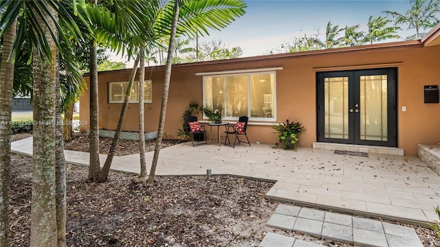 rear view of property with french doors and a patio area