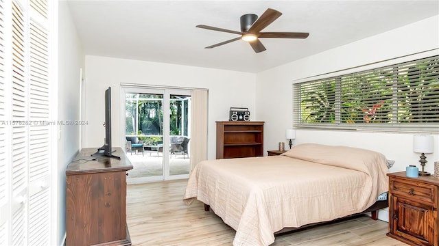 bedroom with light hardwood / wood-style flooring, access to outside, and ceiling fan