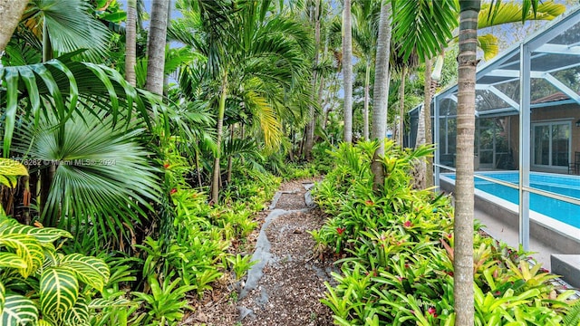 view of yard featuring glass enclosure