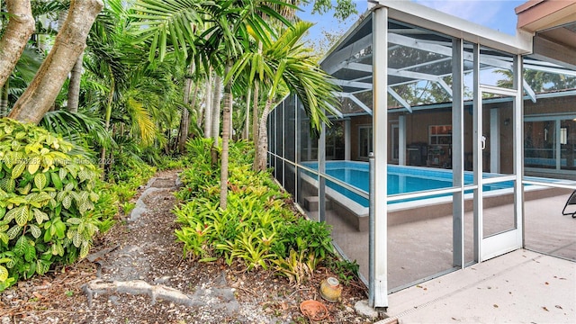 view of pool with a lanai and a patio area