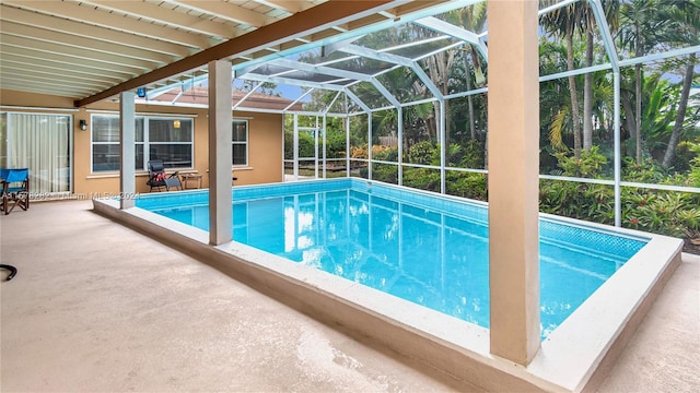 view of pool featuring a patio and glass enclosure