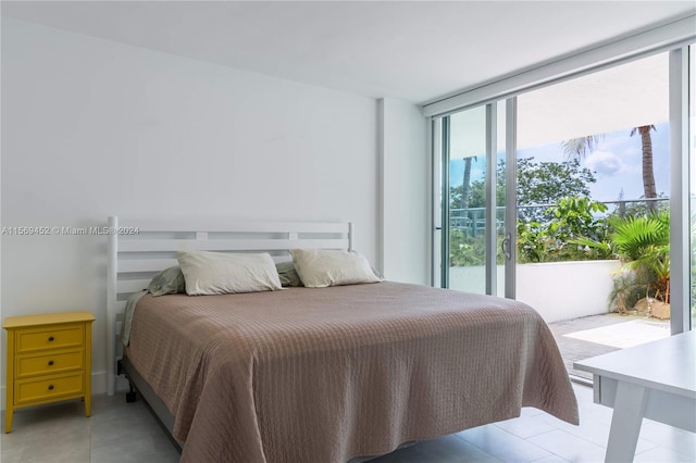 bedroom with tile floors and access to outside