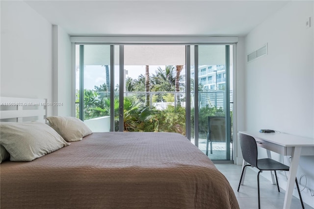 bedroom with floor to ceiling windows, light tile floors, and multiple windows