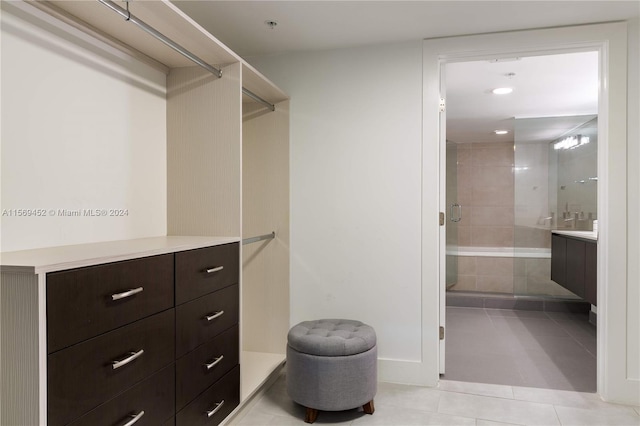 walk in closet featuring light tile floors