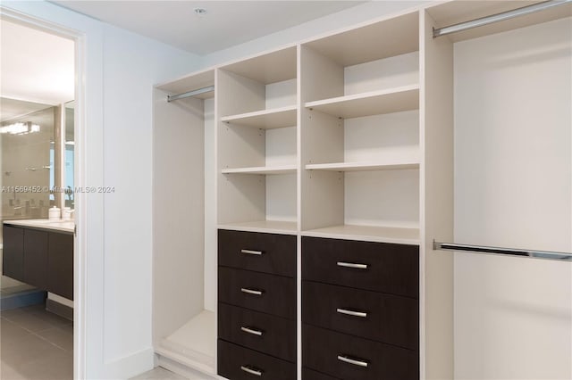 spacious closet with light tile flooring