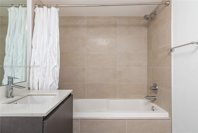 bathroom featuring shower / tub combo and vanity