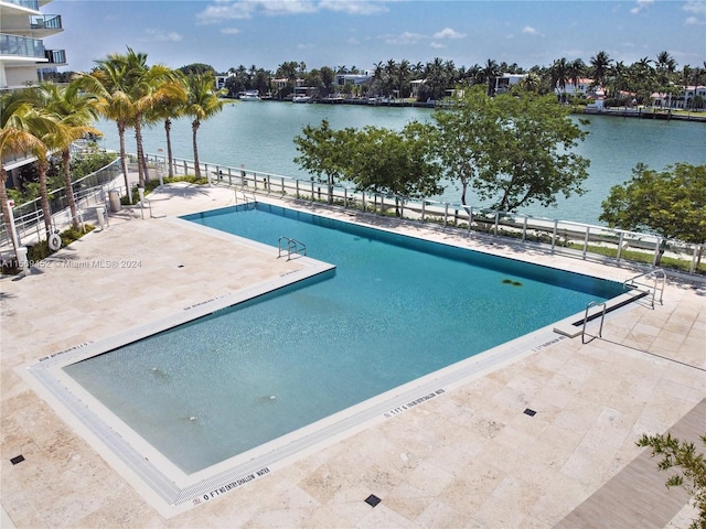 view of pool with a water view