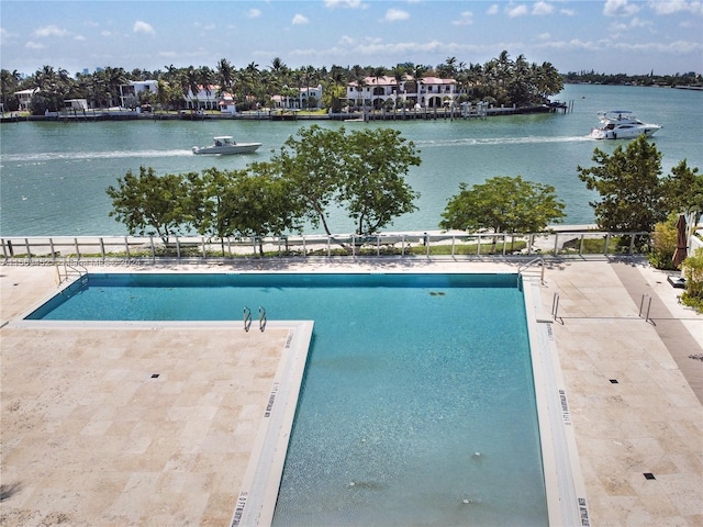 view of swimming pool with a water view