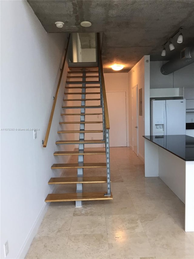 stairs with light tile patterned flooring