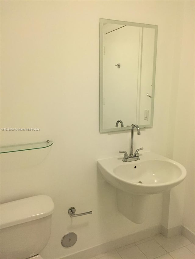 bathroom featuring tile patterned flooring and toilet