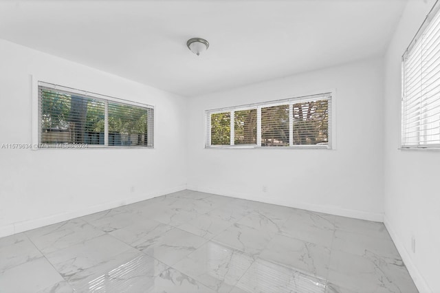 spare room featuring light tile floors