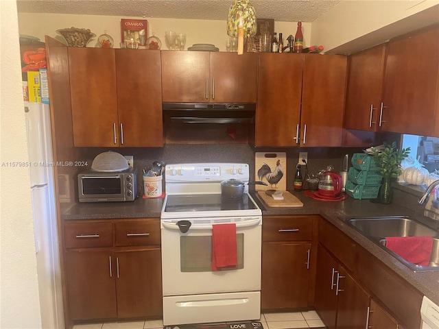 kitchen with white appliances, light tile flooring, sink, range hood, and a textured ceiling