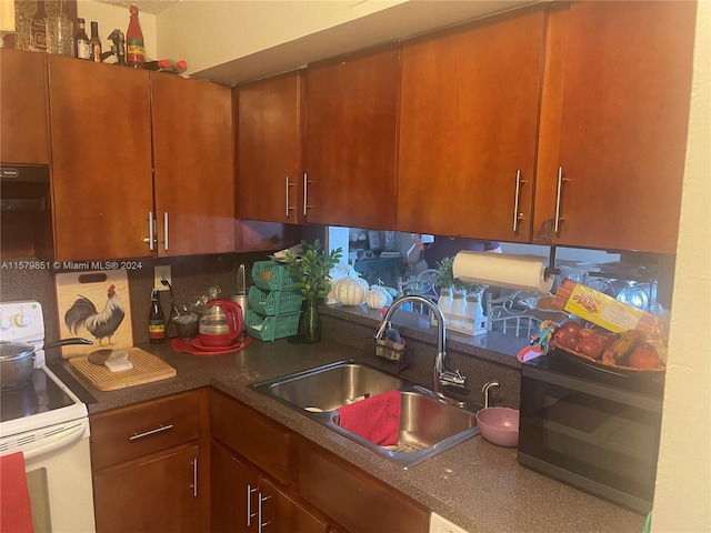 kitchen with extractor fan, white range with electric cooktop, and sink