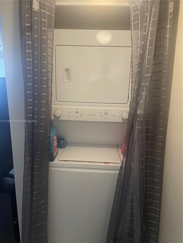 laundry area featuring stacked washer and dryer