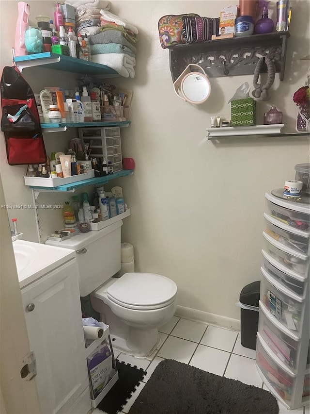 bathroom featuring vanity, tile floors, and toilet