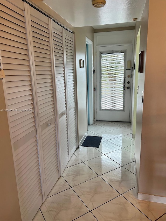 entryway with light tile patterned floors