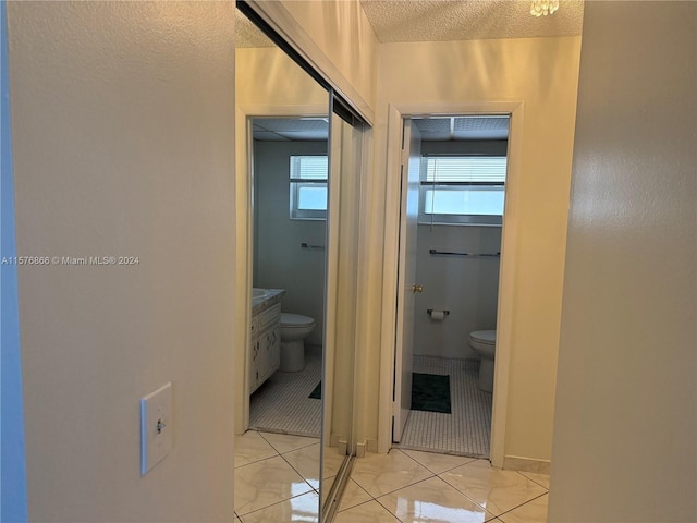 hallway featuring light tile patterned floors