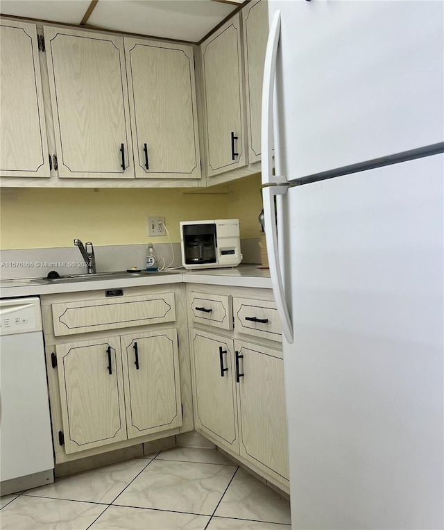 kitchen featuring white appliances and sink