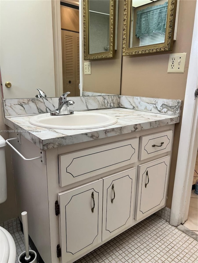 bathroom with tile patterned floors and vanity