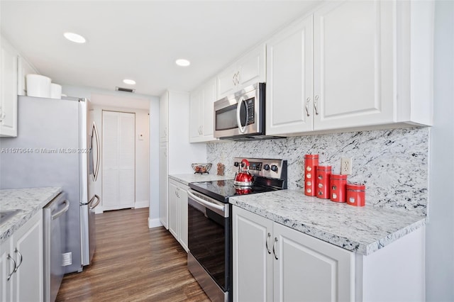 kitchen with stainless steel appliances, white cabinets, tasteful backsplash, and dark hardwood / wood-style flooring