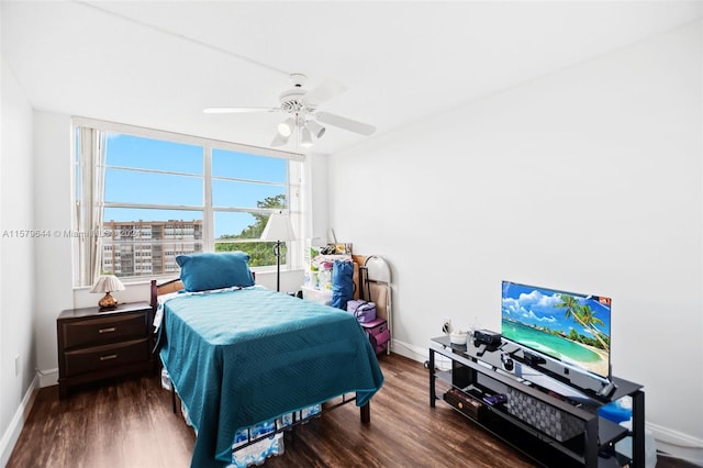 bedroom with ceiling fan and dark hardwood / wood-style floors