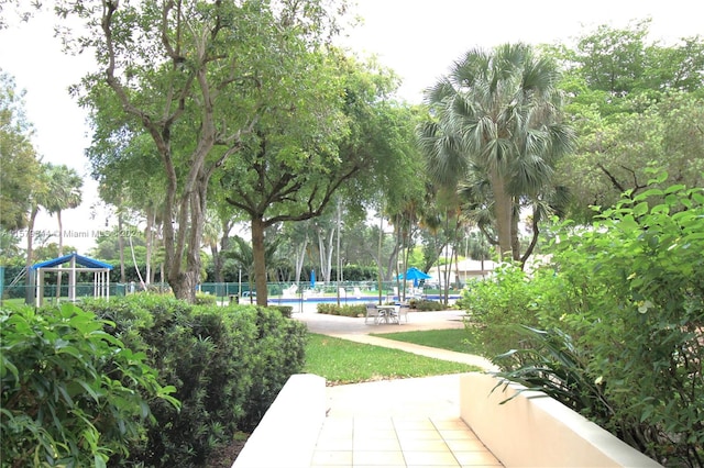 view of home's community with a pool and a patio area