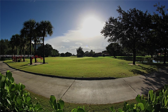 surrounding community with a lawn and a water view