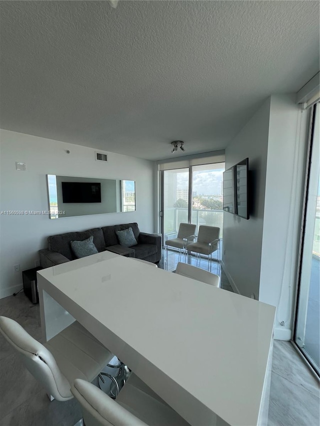 dining space with a textured ceiling