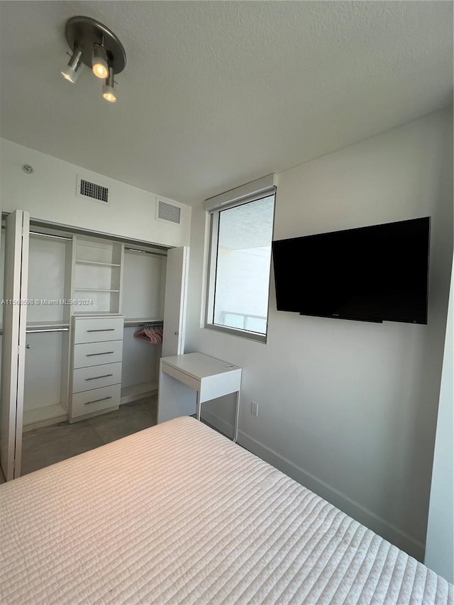 unfurnished bedroom featuring a closet and a textured ceiling