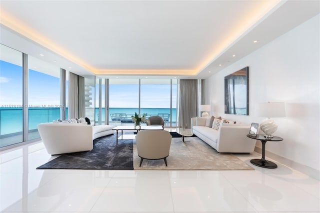 tiled living room featuring expansive windows and a water view