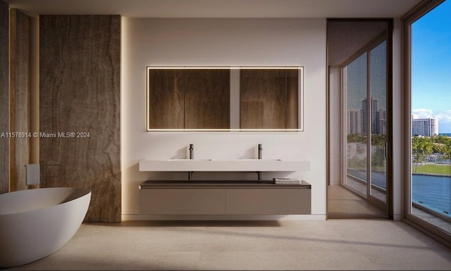 bathroom featuring a bath to relax in, vanity, and expansive windows