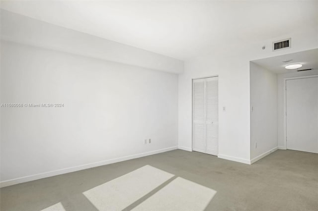 unfurnished bedroom featuring carpet and a closet