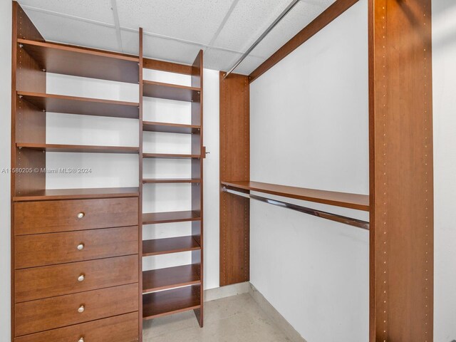 walk in closet with a paneled ceiling