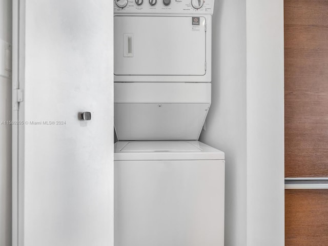 laundry room with stacked washer / dryer