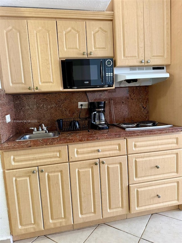 kitchen featuring light brown cabinets, sink, tasteful backsplash, white gas cooktop, and light tile patterned floors