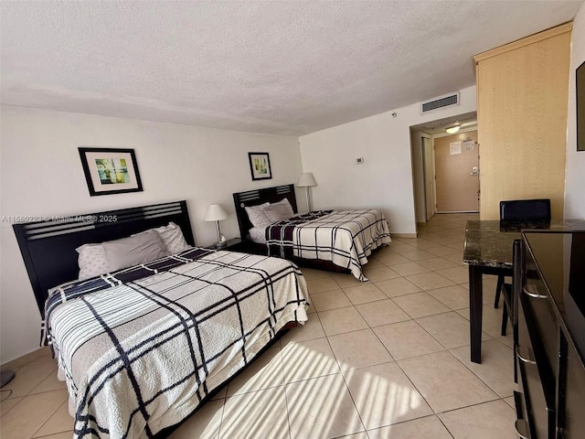 tiled bedroom featuring a textured ceiling