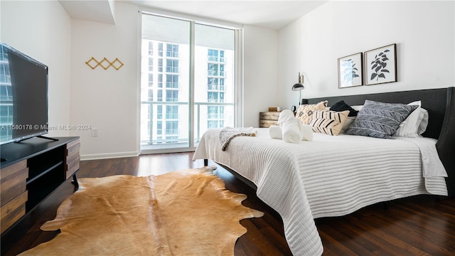 bedroom with dark hardwood / wood-style flooring