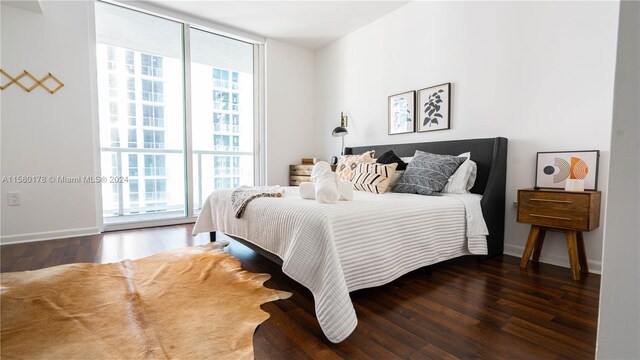 bedroom featuring dark wood-type flooring and access to outside