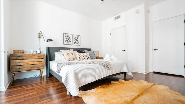 bedroom featuring dark hardwood / wood-style flooring