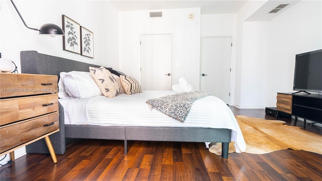 bedroom with dark hardwood / wood-style flooring