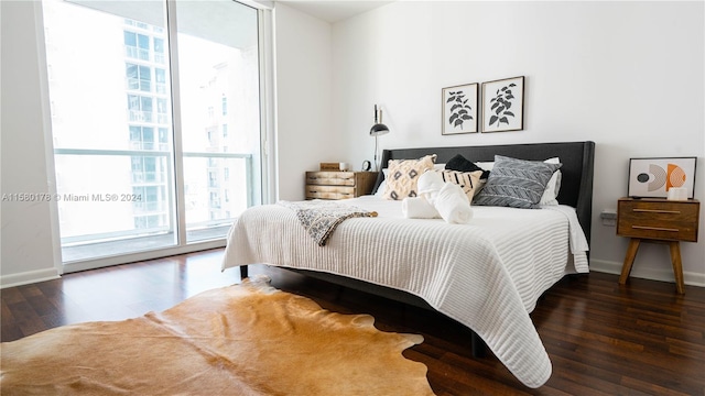 bedroom featuring dark hardwood / wood-style floors and access to exterior